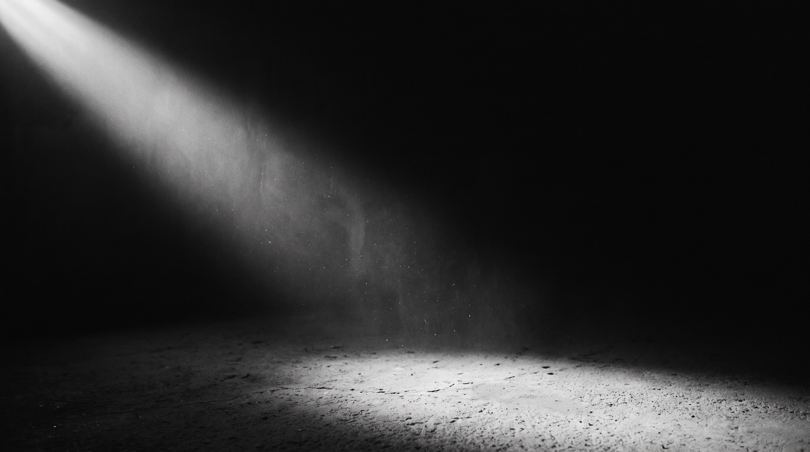 A shaft of daylight falling through darkness